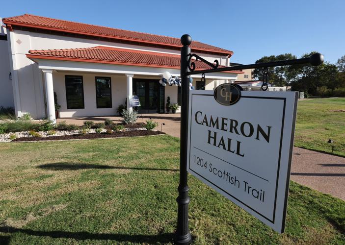 Sign for Cameron Hall, located at 1204 Scottish Trail, in front of a modern building with a red-tiled roof.