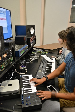 Individual with keyboard hooked to computer