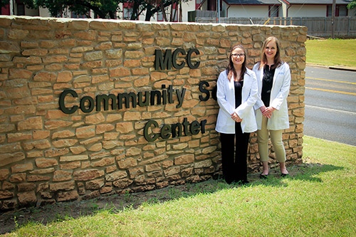 doctors standing in front of sign