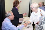 Bob Woodward shaking hands with a woman