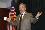 Reich with arms up and holding cup in one hand