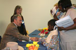 Reich at desk speaking with people