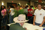 Watson wearing hat with people coming up to him