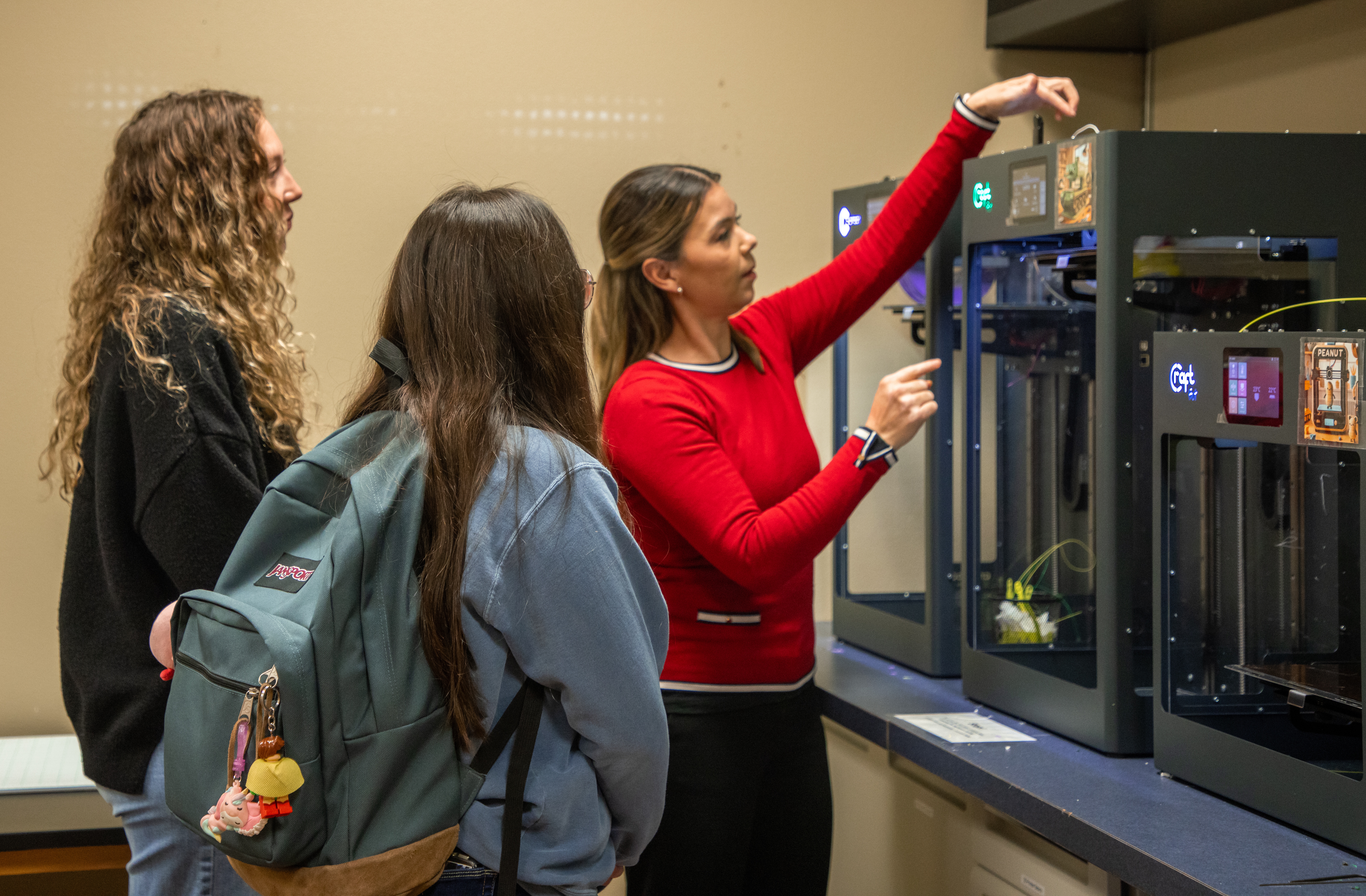 Students watching instructor work with 3D Printer