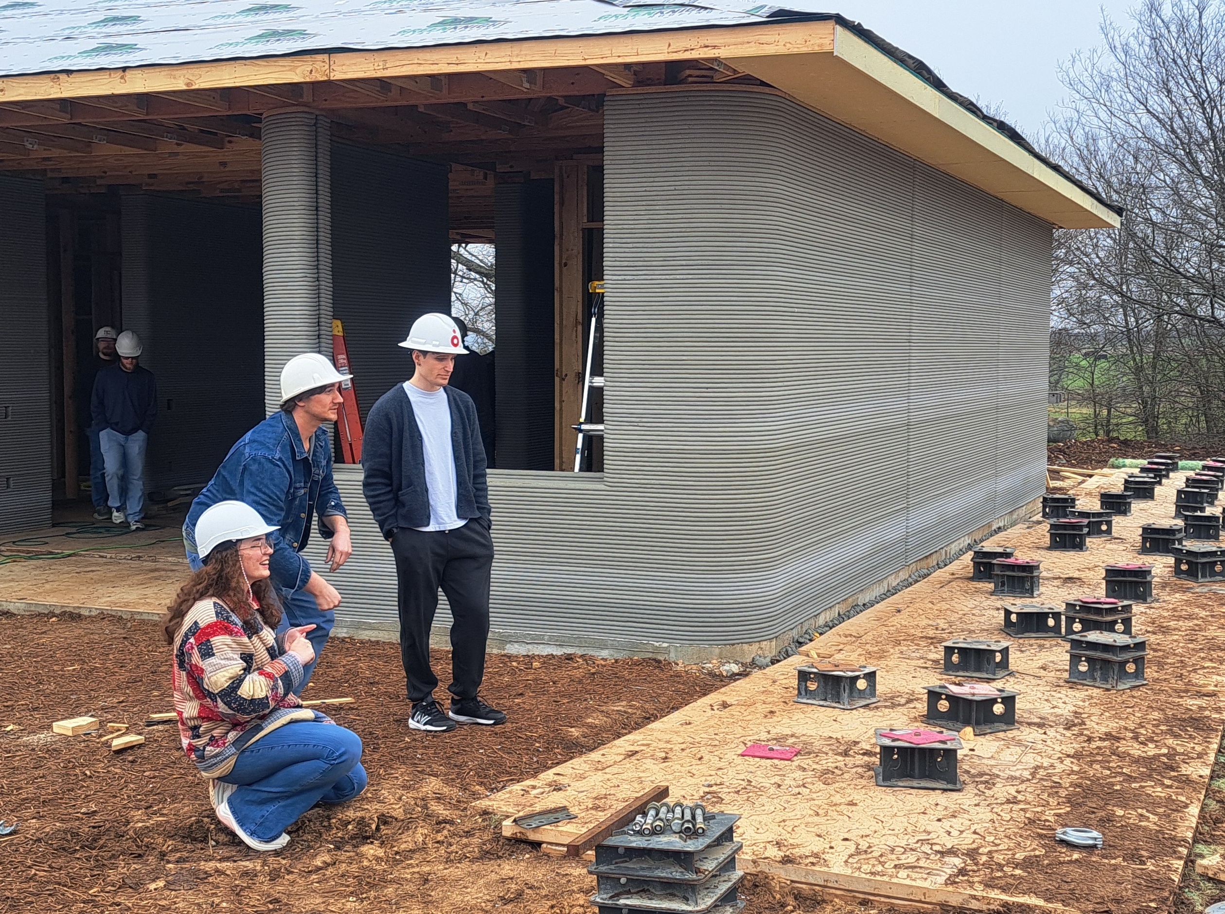 Students touring 3D printed home construction site