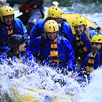 Group of People wearing blue with yellow helmets in the water