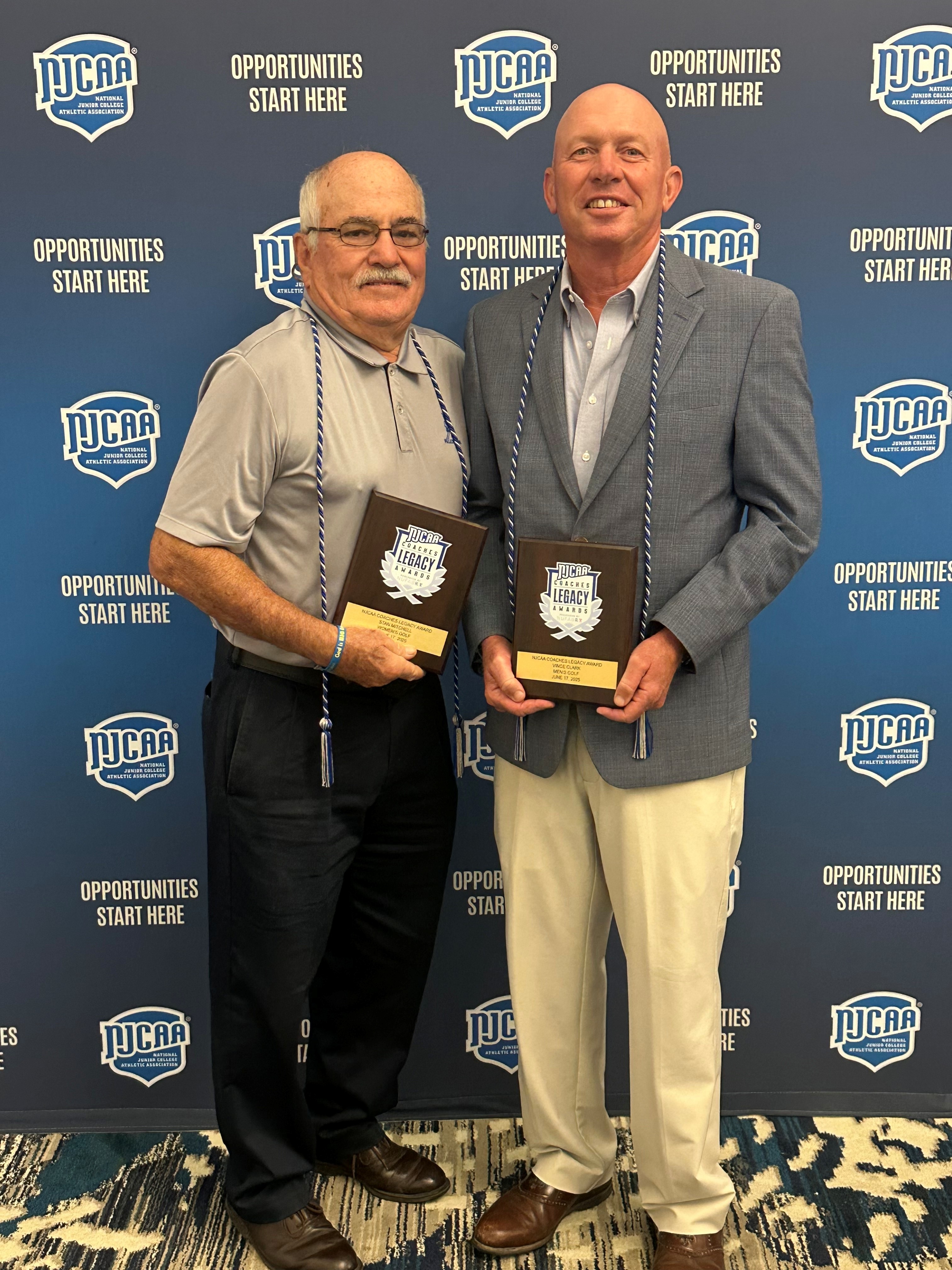 Stan Mitchell and Vince Clark standing together with their awards