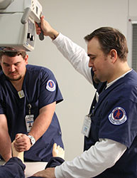 students operating on sim dummy