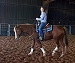 Woman riding brown horse