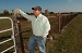 Man standing by side of fence