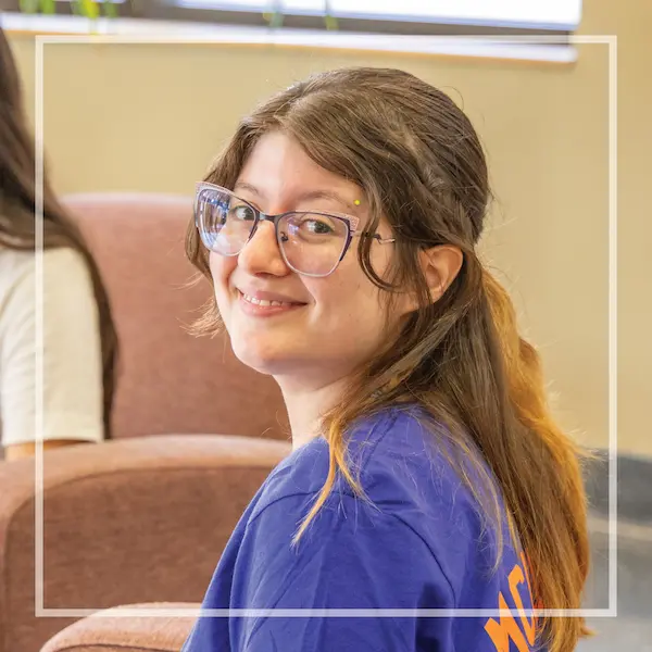 Ambrea Rodriguez, MCC Medical Lab Assistant student, smiling on campus wearing a blue MCC t-shirt.