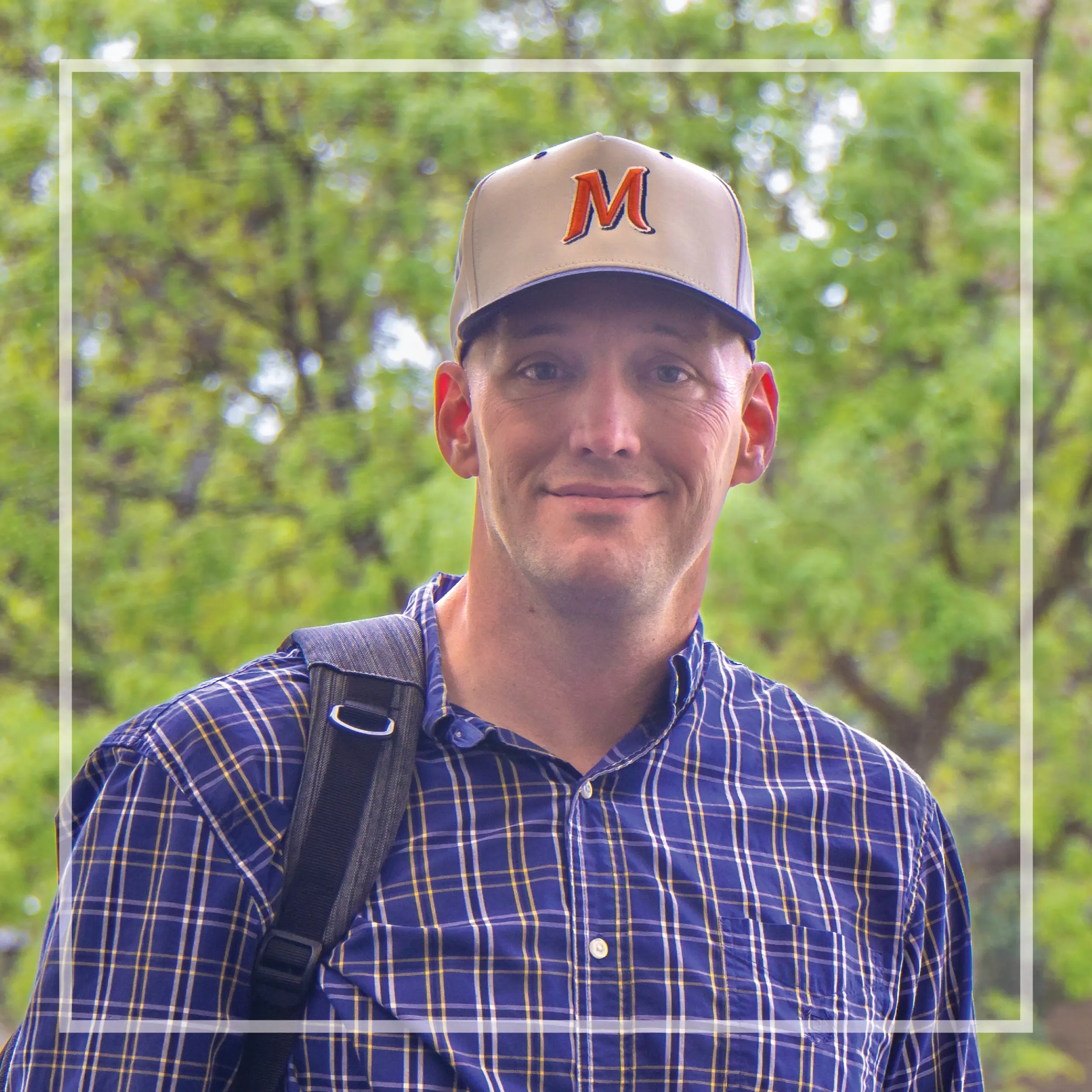 Headshot of Matthew Travis with white translucent border around it.