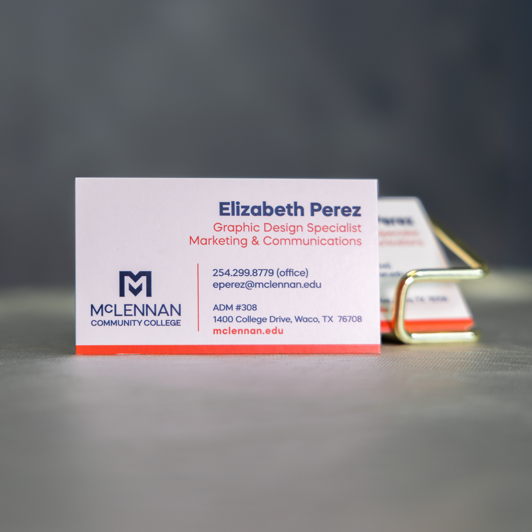 Business card for Elizabeth Perez, Graphic Design Specialist at McLennan Community College, featuring contact information and college branding.