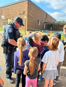Policeman with children for kids college