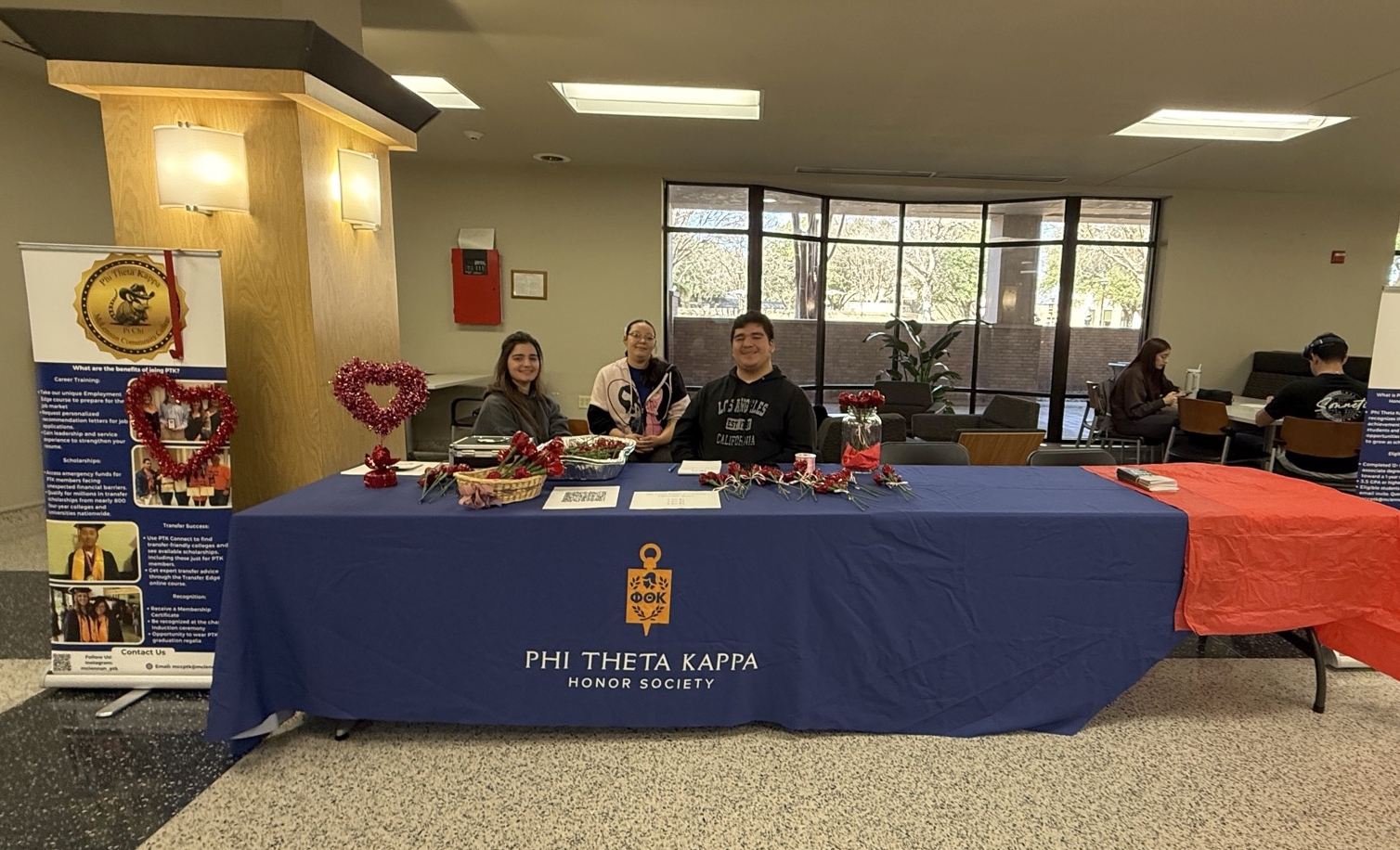 Pi Chi students staff a PTK table to sell candy roses for Valentine's Day