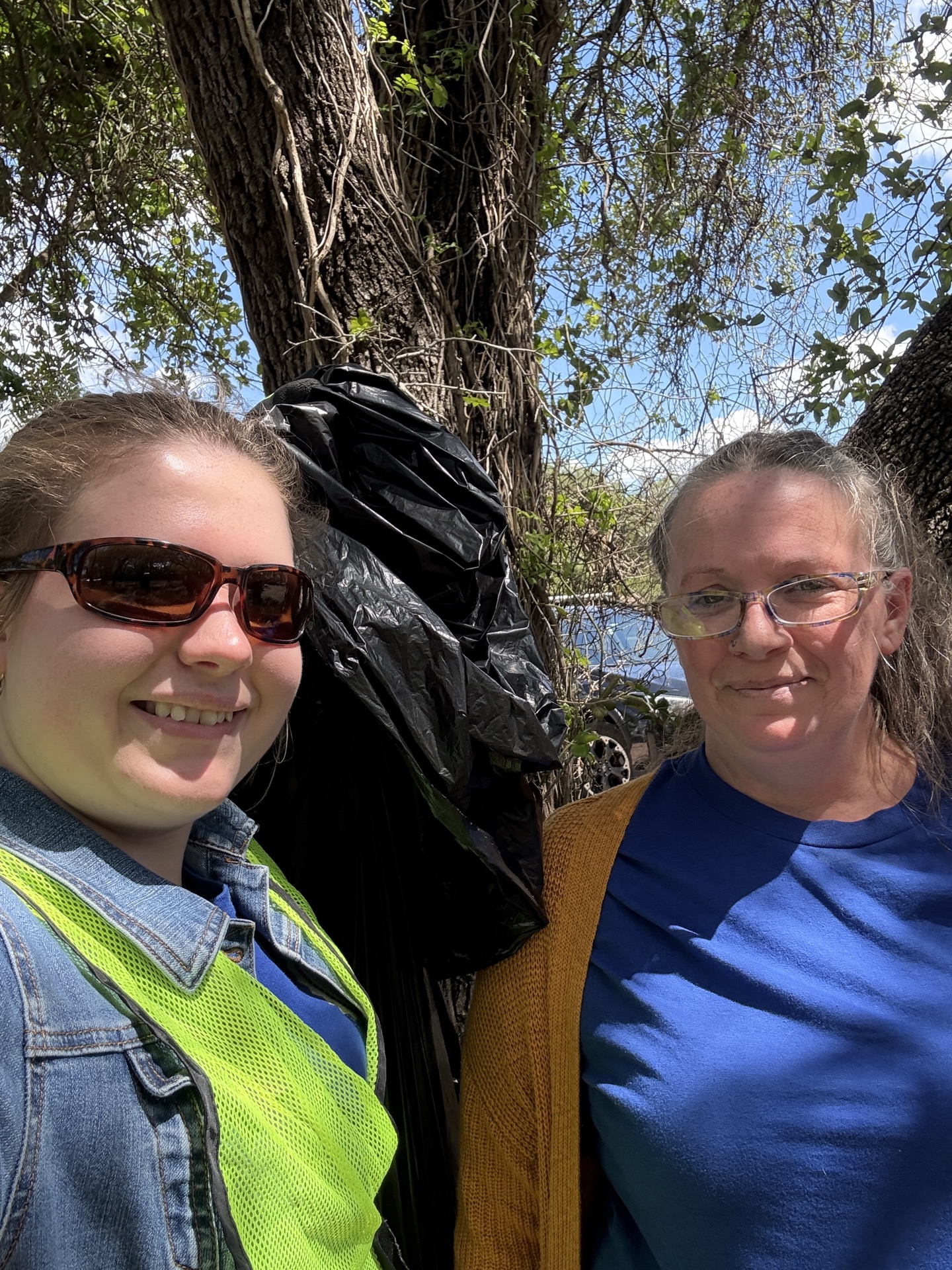 Pi Chi members posing with trash bag