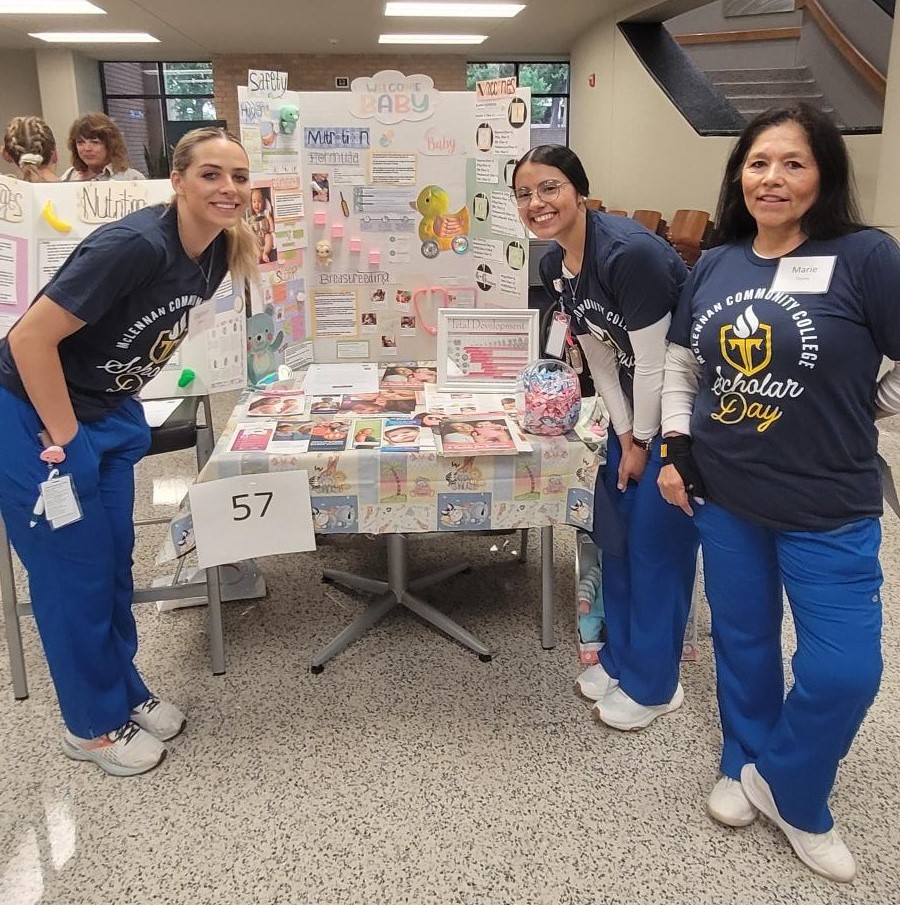 Nursing Students with Scholar Day Display