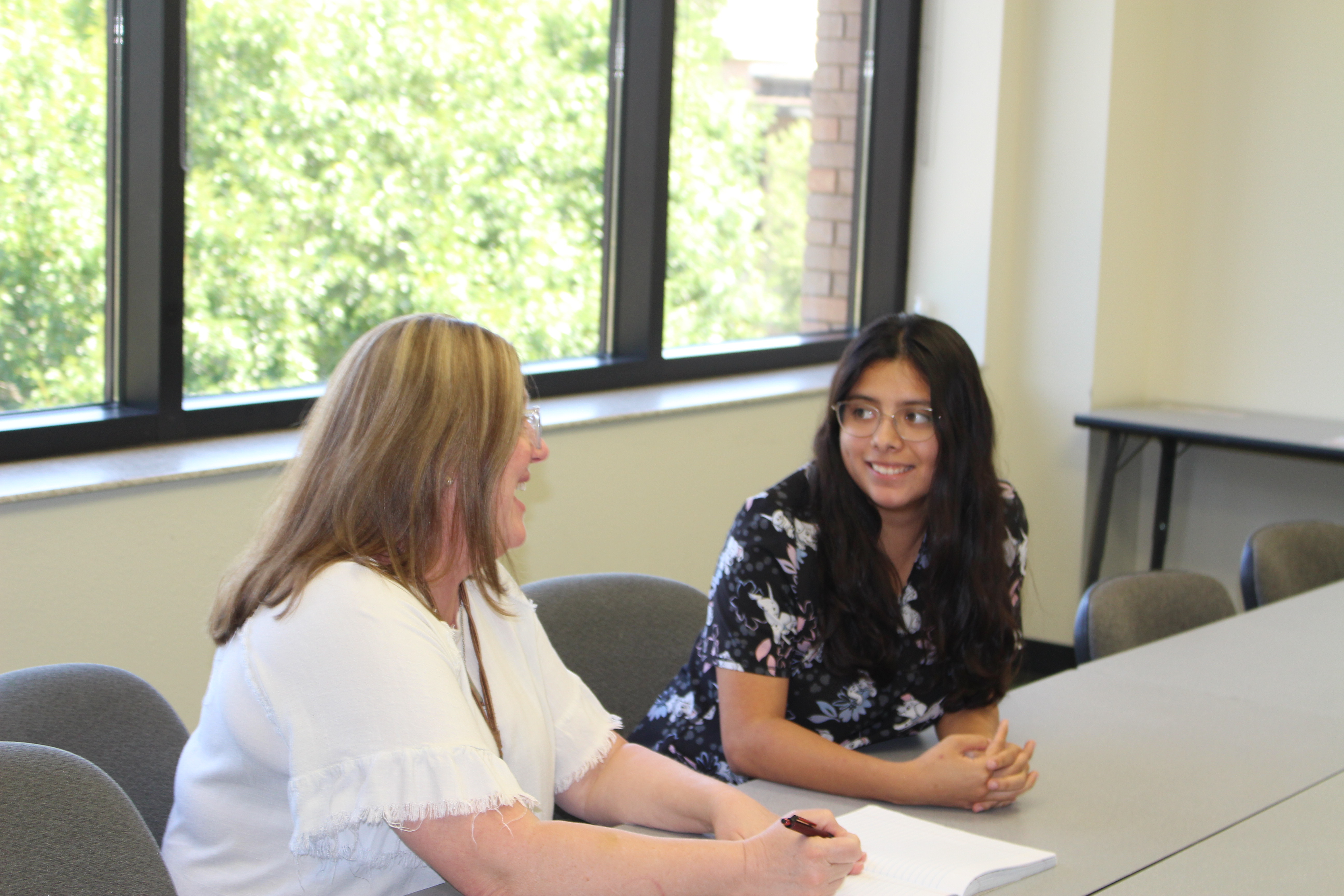 Image of a success coach speaking with a student.
